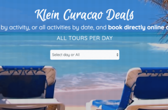 Two empty blue beach chairs face turquoise ocean waves on Curacao’s sandy beach under a clear blue sky. Palm fronds frame the scene. Overlaid white text promotes Klein Curacao tour deals, with a dropdown menu to select tour days or all days.