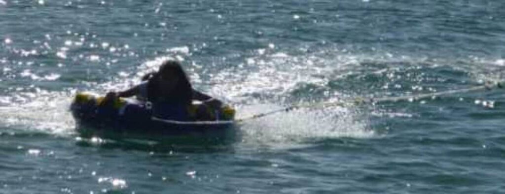 Experience the excitement of Bumper Tube Rides as you hold tight to the handles and race across the water, sunlight sparkling on the surface and a lively wake trailing behind you.