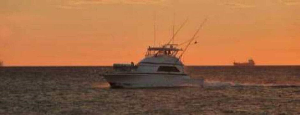 Experience the serene beauty of Curacao with Sunset Boat Tours Curacao—glide across calm waters at sunset as orange skies reflect on the sea, creating a peaceful scene ideal for unforgettable evening cruises.